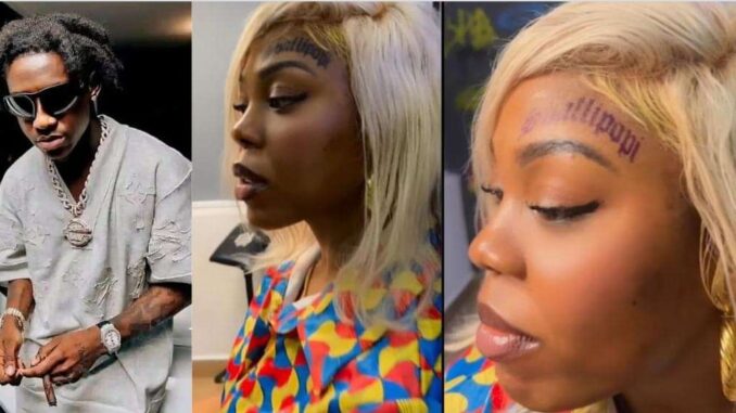 “Product of failed parenting” – Reactions as lady tattoos Shallipopi’s name on her forehead, video trends